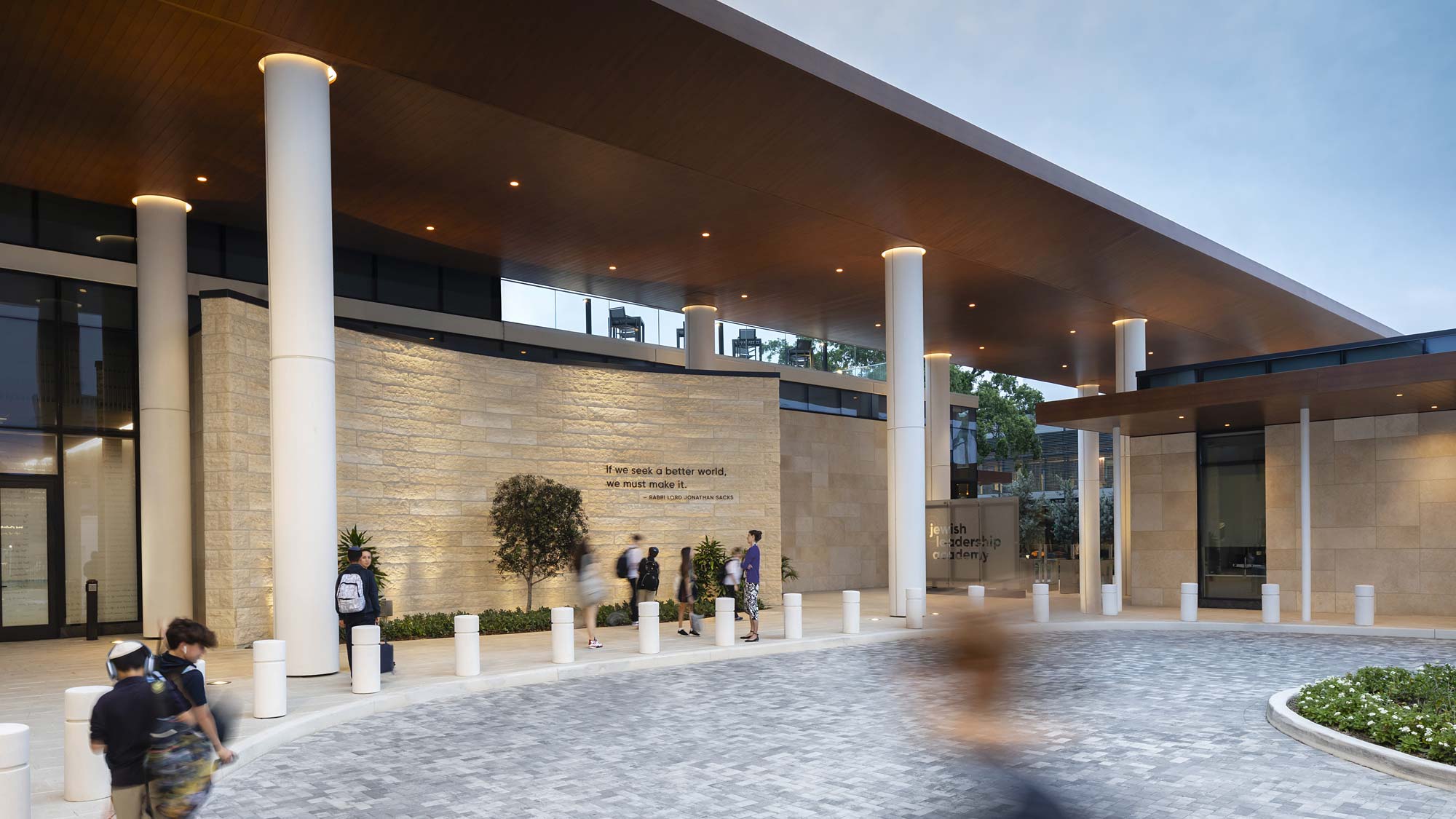 A building with pillars and people.