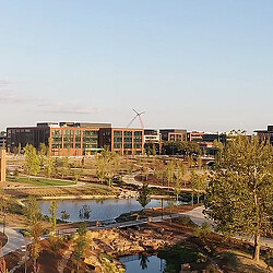 A building with a pond in front of it.