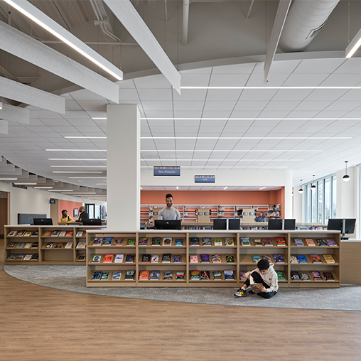 A few people sitting in a library.