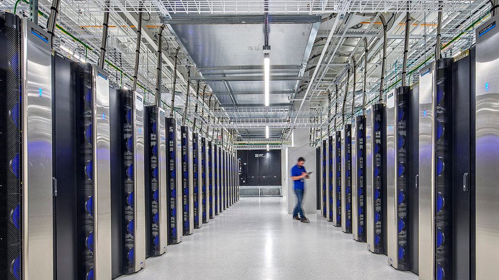 A person walking in a server room.