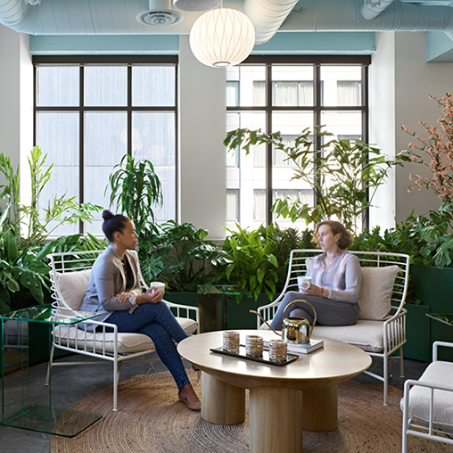 A couple of women sitting in chairs.