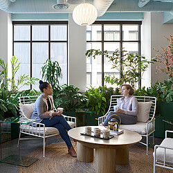 A couple of women sitting in chairs.