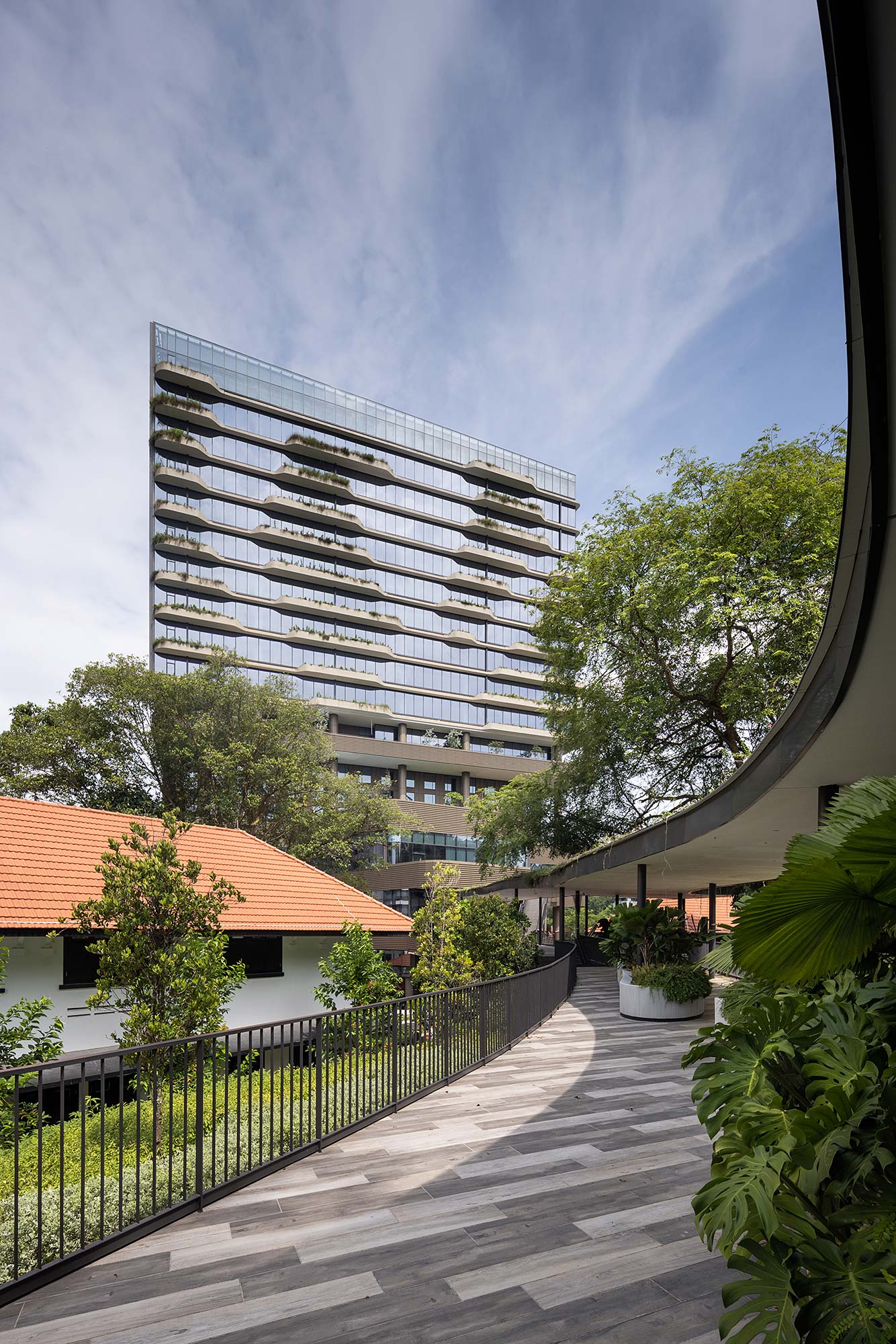 A building with a fence and trees.