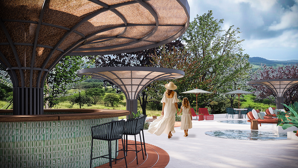 A couple of people walking on a deck by a pool.