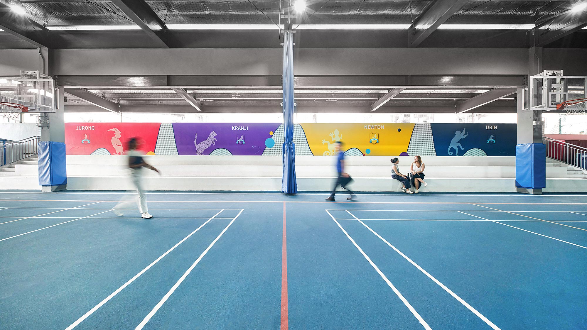 People playing tennis in a stadium.