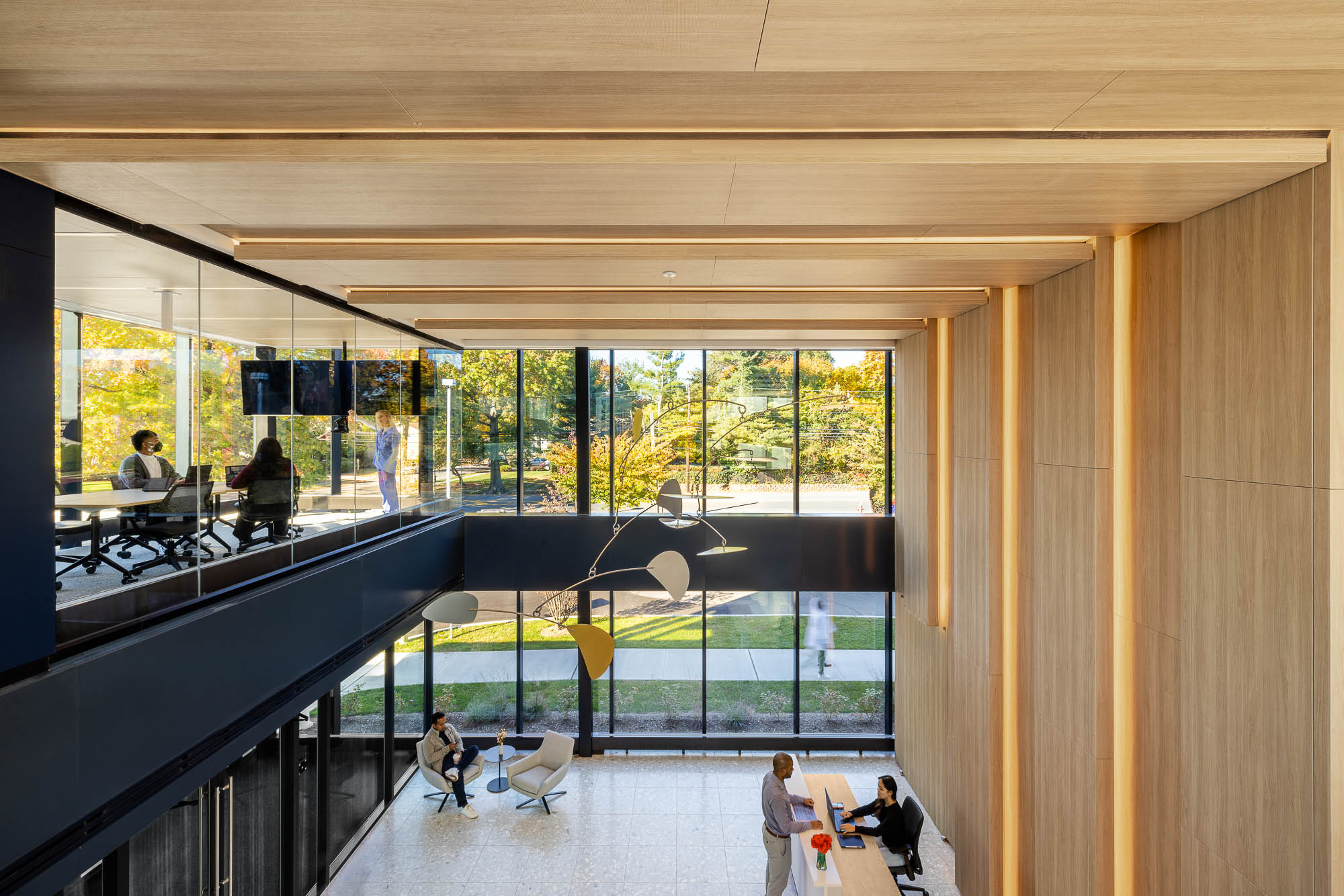 A group of people in a room with large windows.
