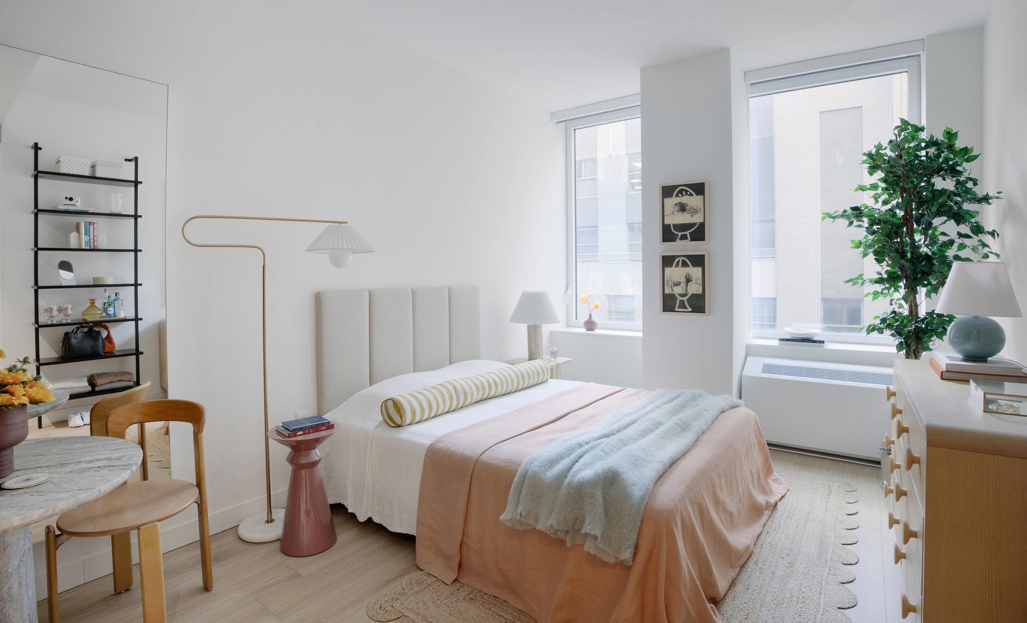 A bedroom with a bed and a table.