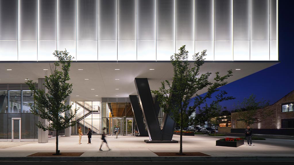 A large building with a large sculpture in the front.