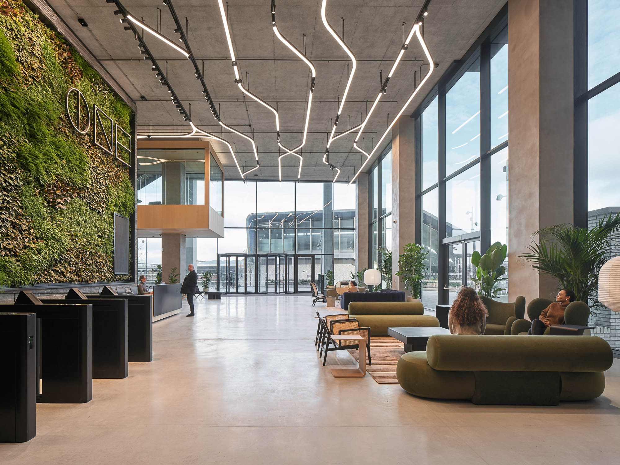 ONE Station Hill lobby with floor to ceiling windows and biophilic wall