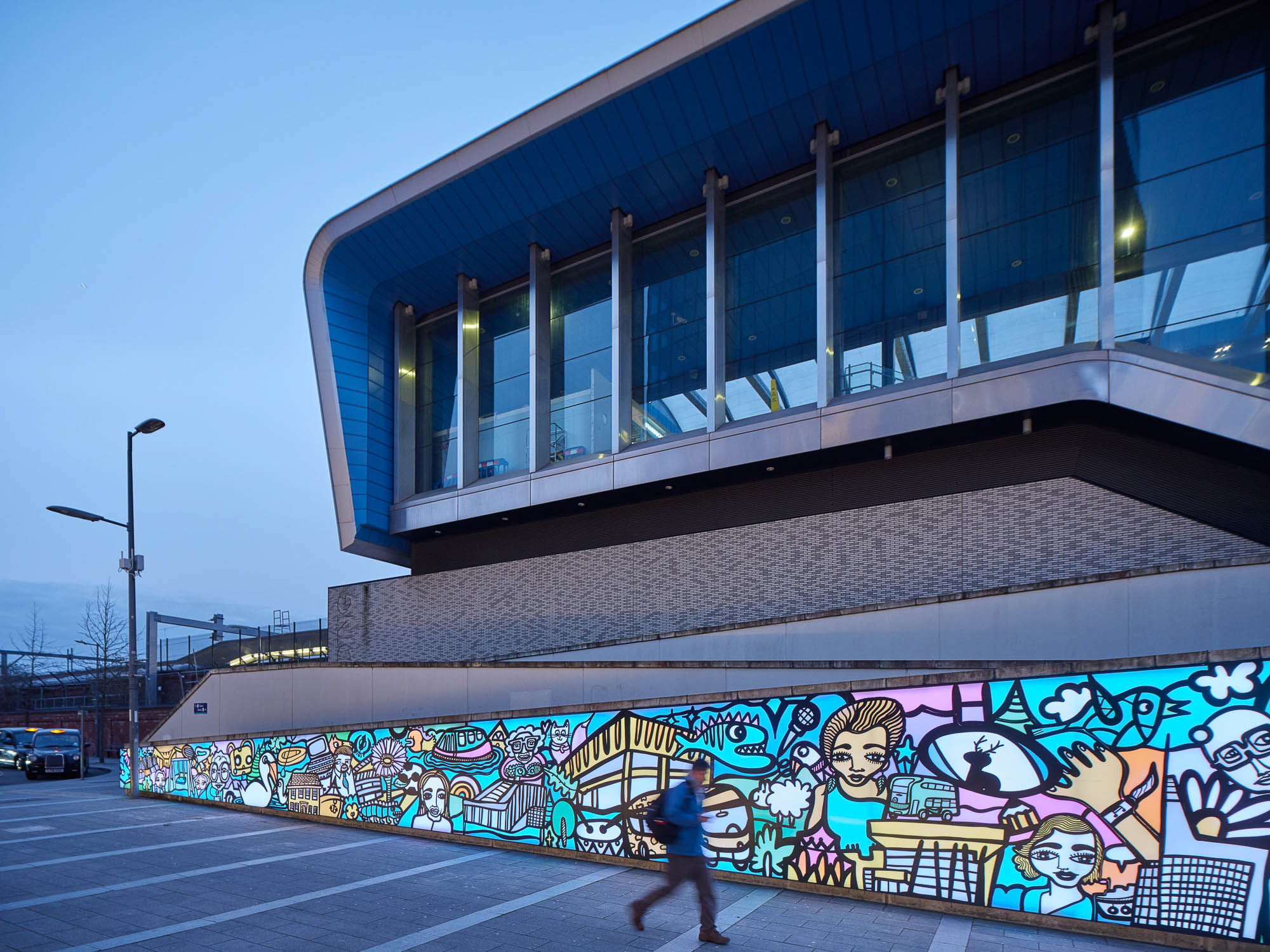 ONE Station Hill building exterior with colorful, illuminated mural