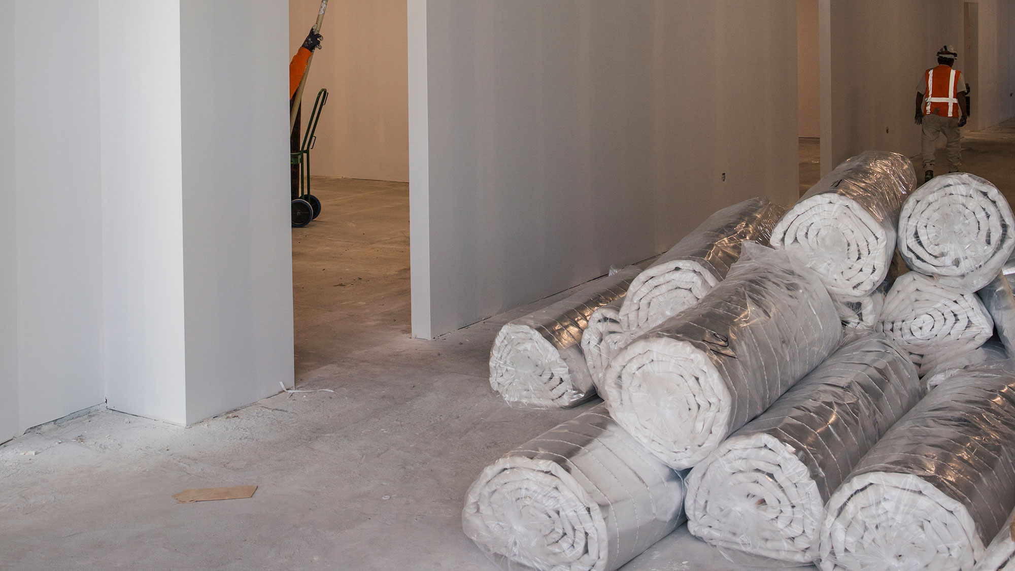 A room with a pile of white silk rolls.