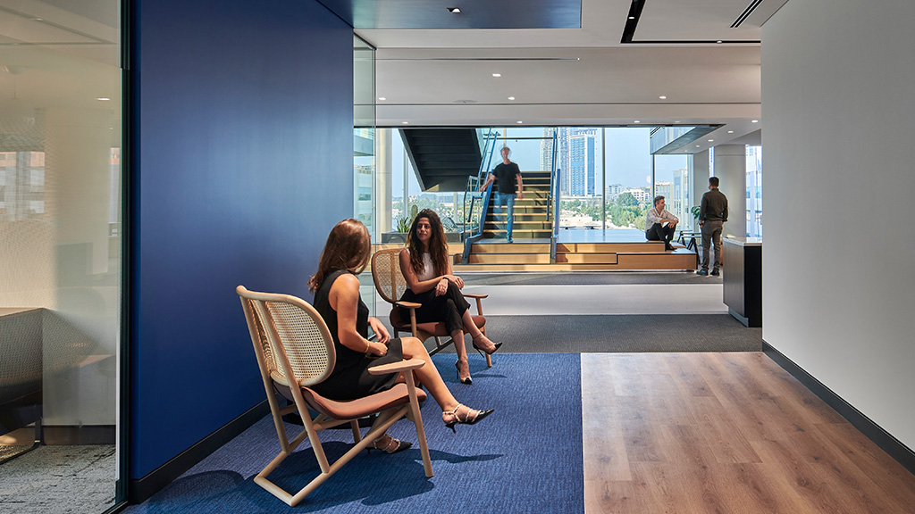 Two woman sitting and talking at a financial services headquarters in Dubai