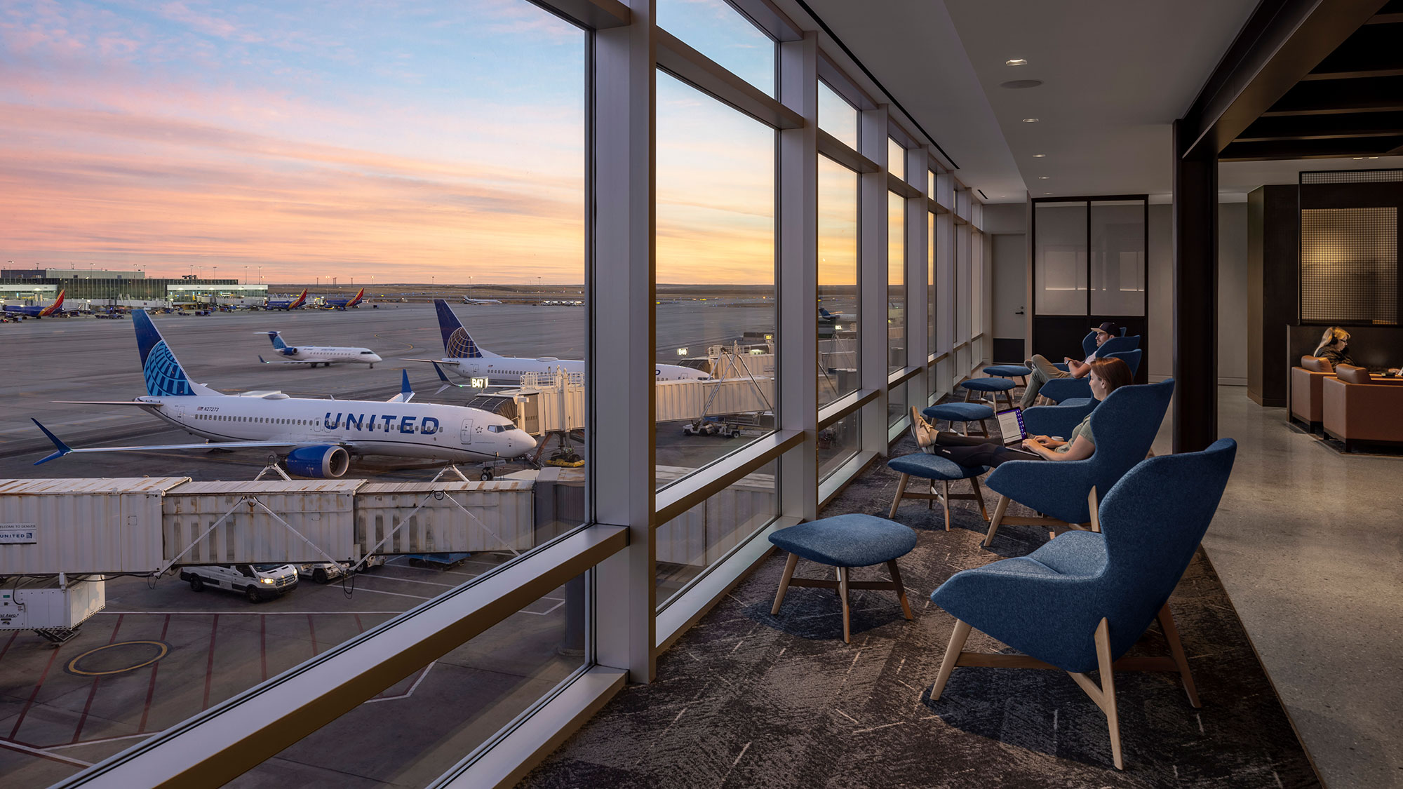 An airport with blue chairs.