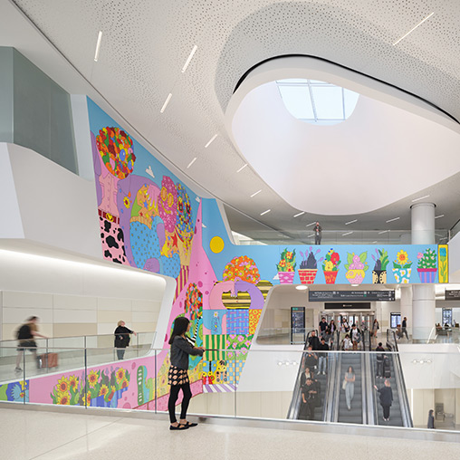 SFO Harvey Milk Terminal 1 colorful mural and skylight by escalators