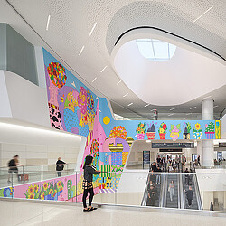 SFO Harvey Milk Terminal 1 colorful mural and skylight by escalators