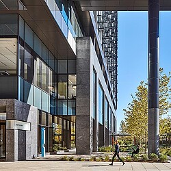 A person walking outside of Mass General Brigham building