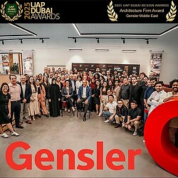 A group of people posing for a photo at the UAP Dubai Design Awards.