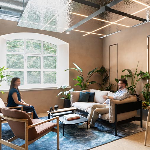 A man and woman are sitting in the Oasis room in Hilson Moran's Living Lab.