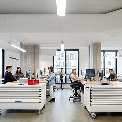 A group of young designers collaborating in a workspace.