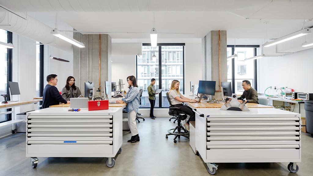 A group of young designers collaborating in a workspace.