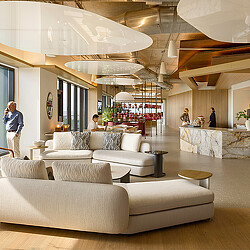 A room with a couch and a table with people in it.