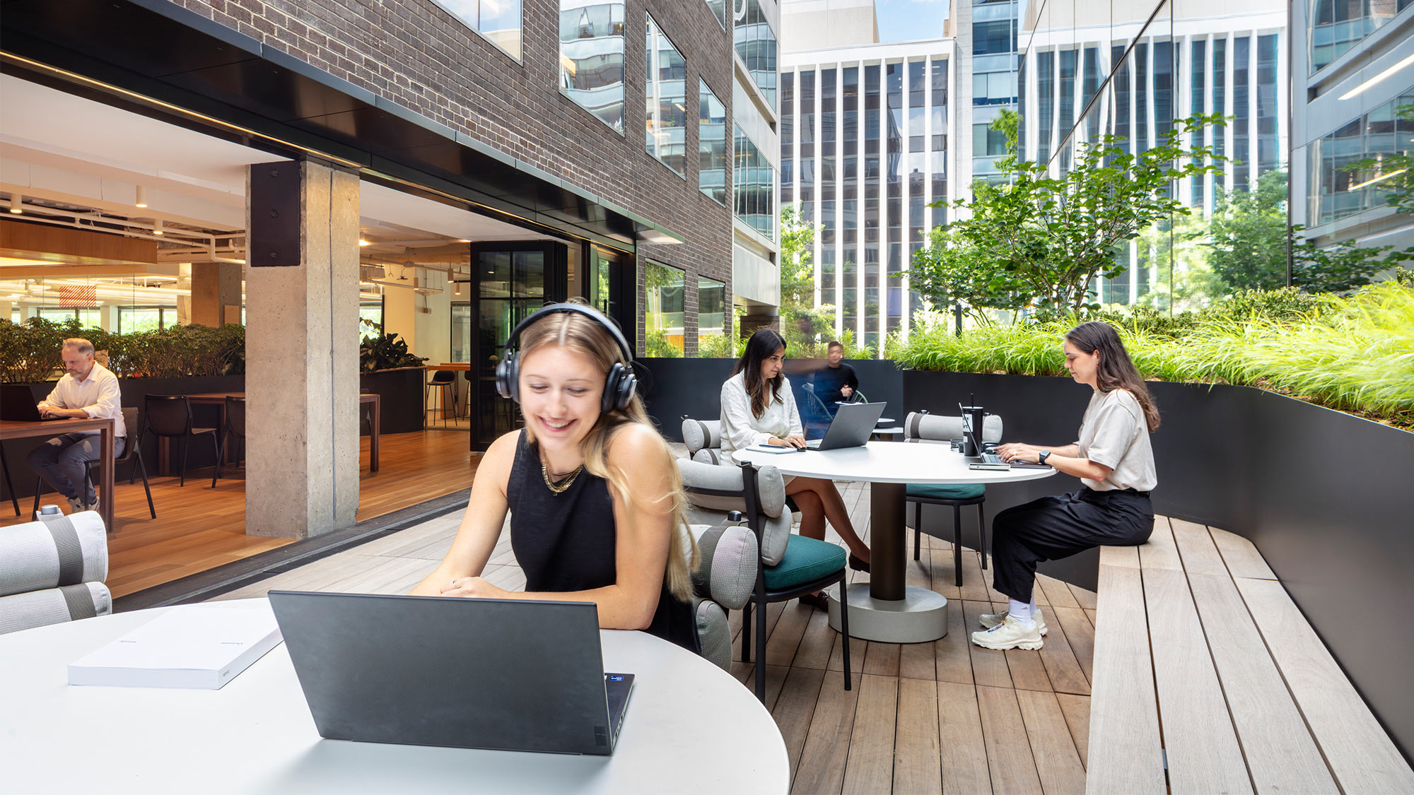 Employees working on laptops on Gensler Washington, D.C. terrace