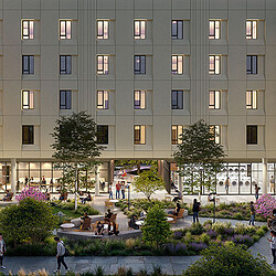 A building with many windows and people walking around.