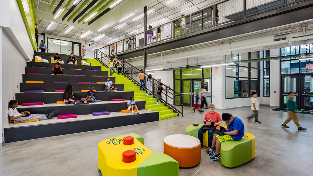 People sitting on benches in a building.