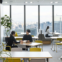 A group of people sitting at tables.