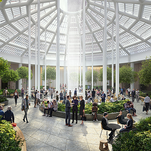 A group of people in a large building with a glass roof.