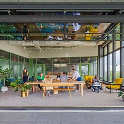 People sitting at tables outside a building.