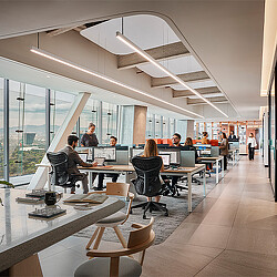 A group of people sitting at tables in a room with windows.