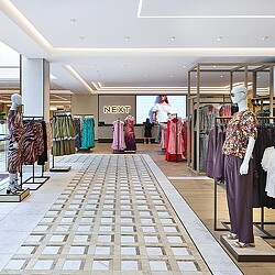 A person walking through a clothing store.