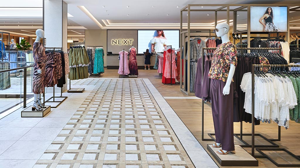 A person standing in a clothing store.